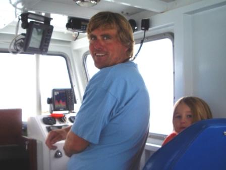 Jim Richeson at the wheel of the "Top Notch"